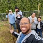 image of men and women at the groundbreaking of our cultural community garden